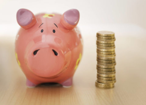 piggy bank and stack of coins