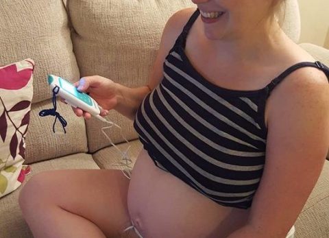woman using maternity tens machine at home