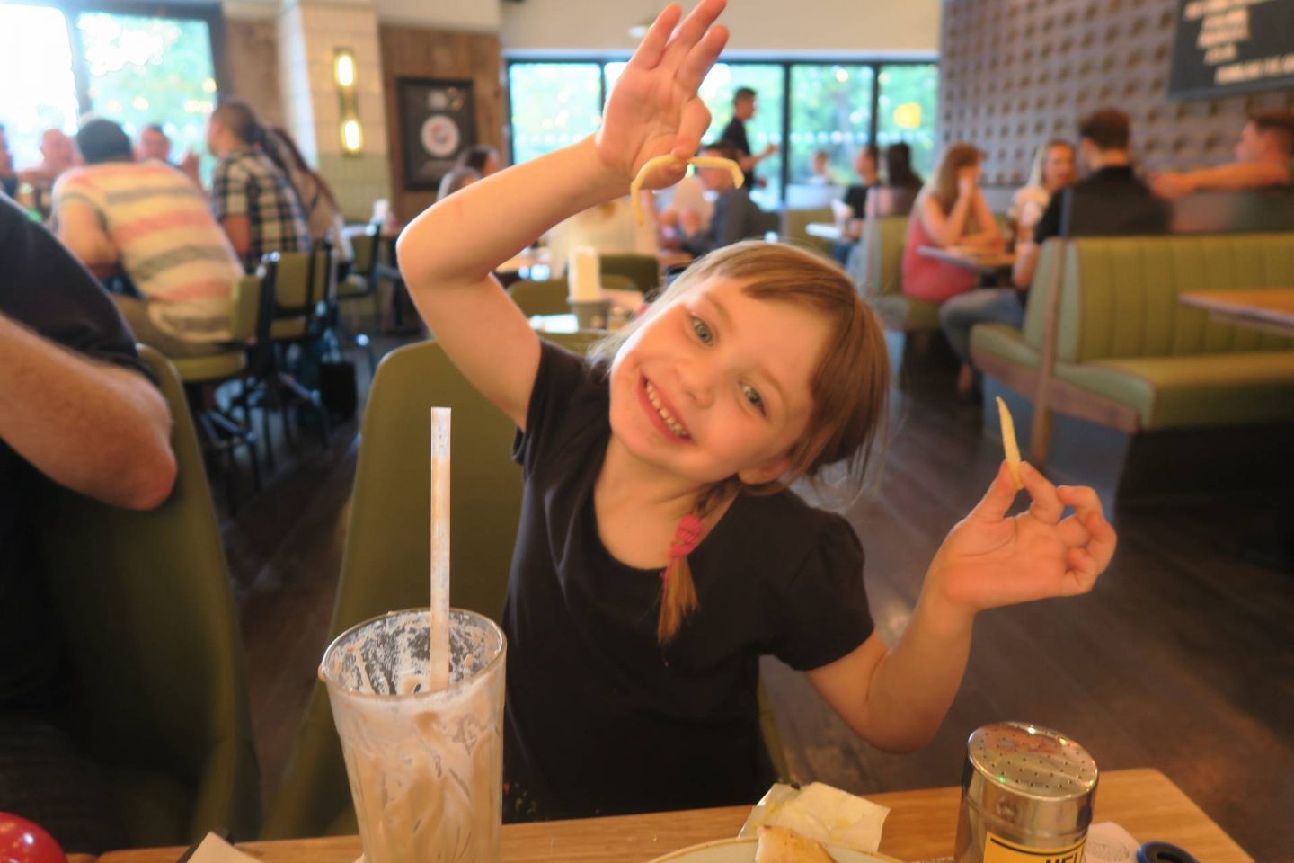little girl happy in local restaurant with chips maidstone