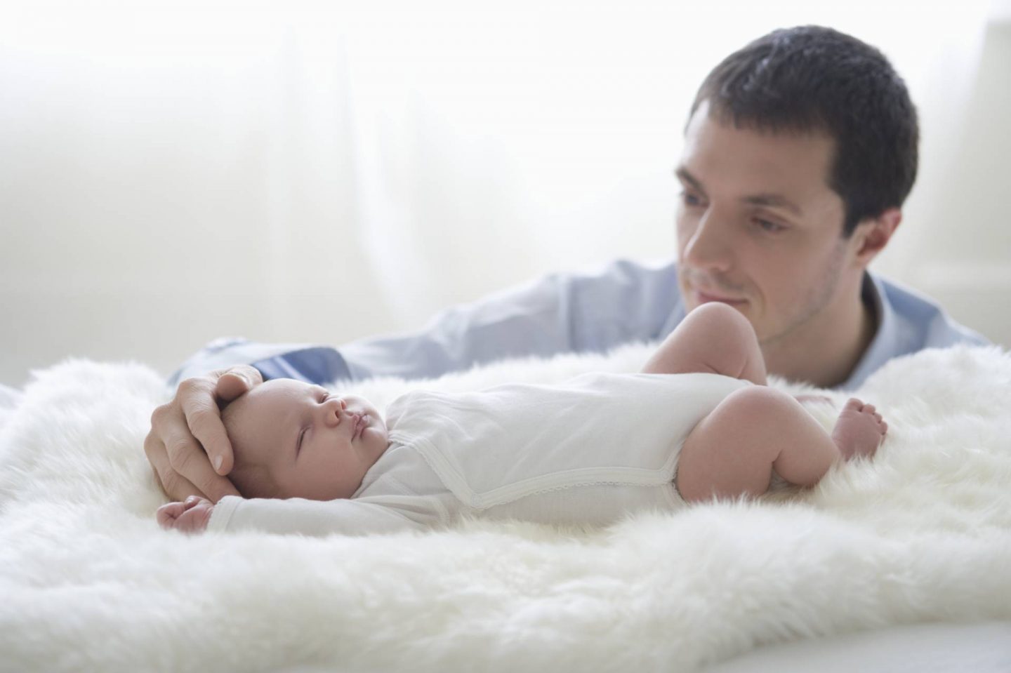 how to dress your baby for summer - dad holding newborn baby in vest