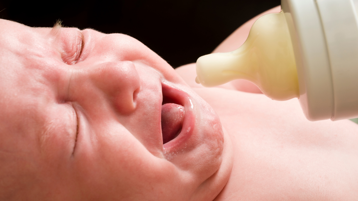 baby crying with bottle