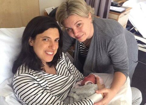 same sex couple with their newborn