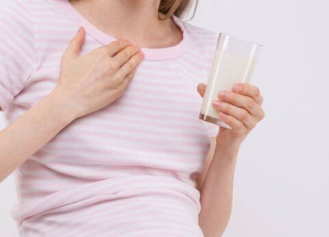 pregnant woman with heartburn/sickness and drink of milk