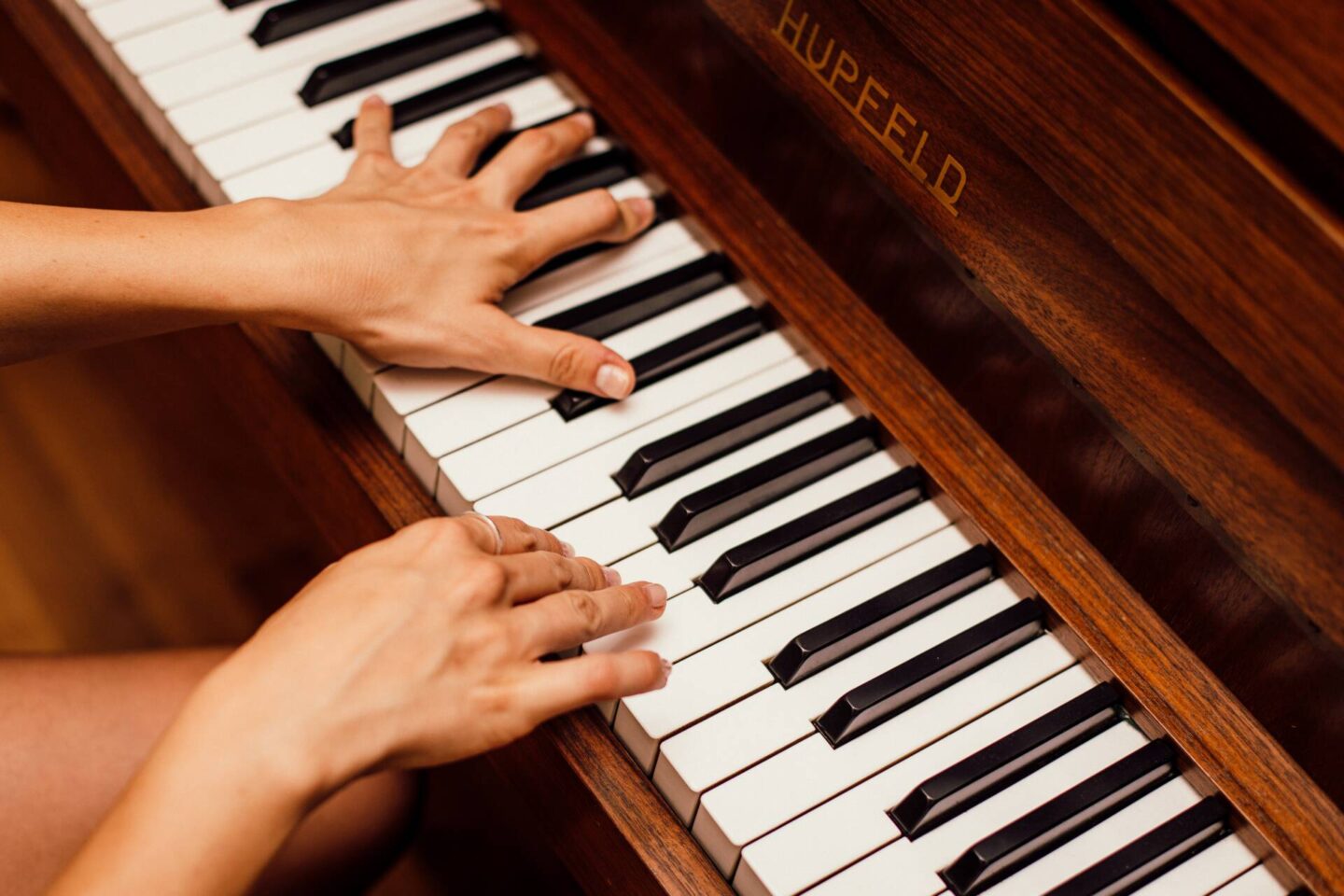 hands playing a piano