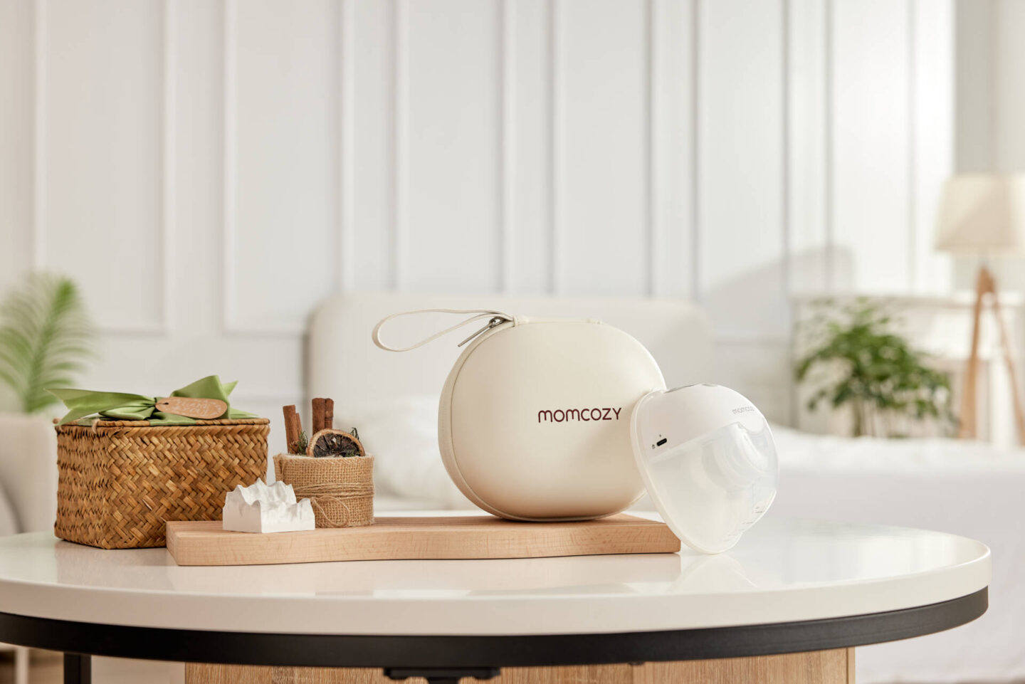 breast pump and back sitting on a table with modern design and cream coloured home.
