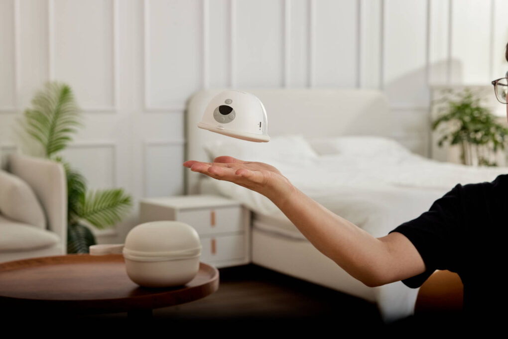 mom holding a breastpump momcozy m5 in modern home