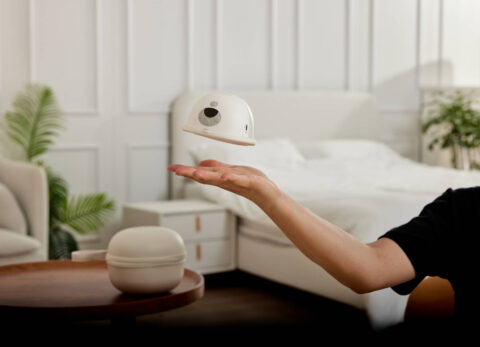 mom holding a breastpump momcozy m5 in modern home