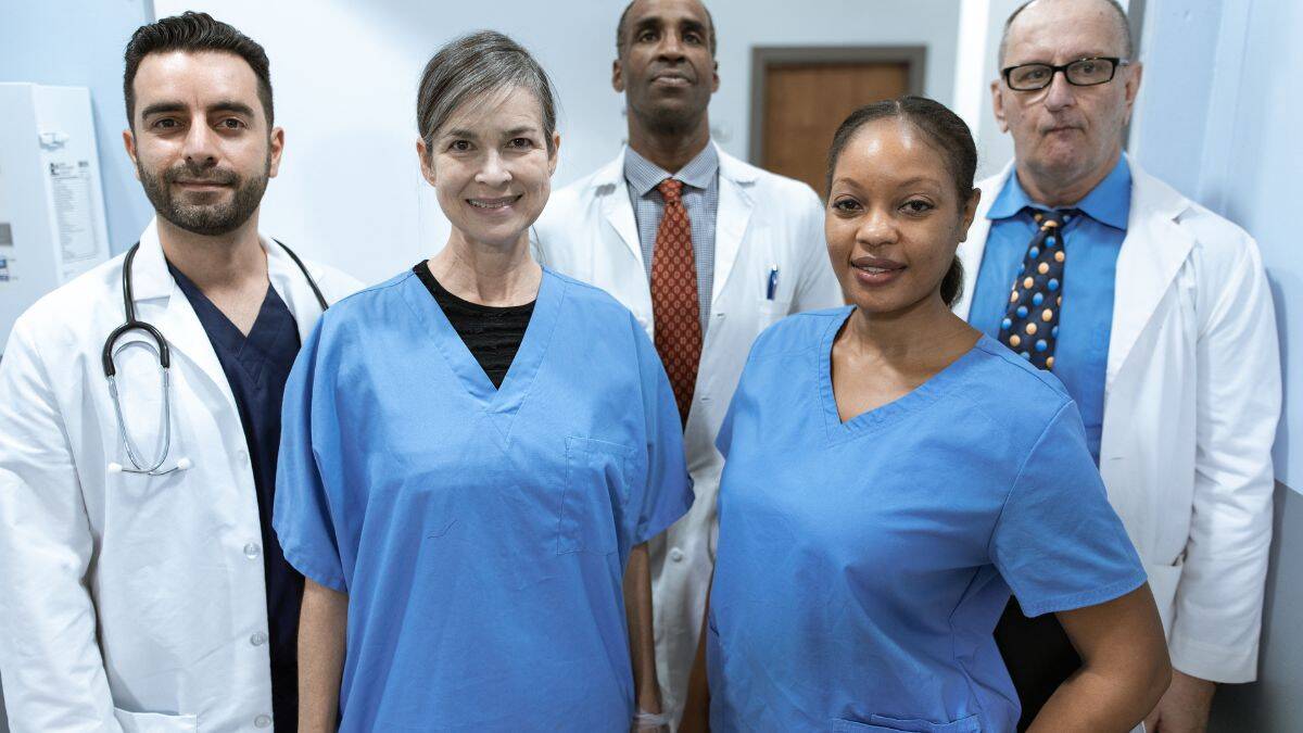 nurses and doctors posing for photo