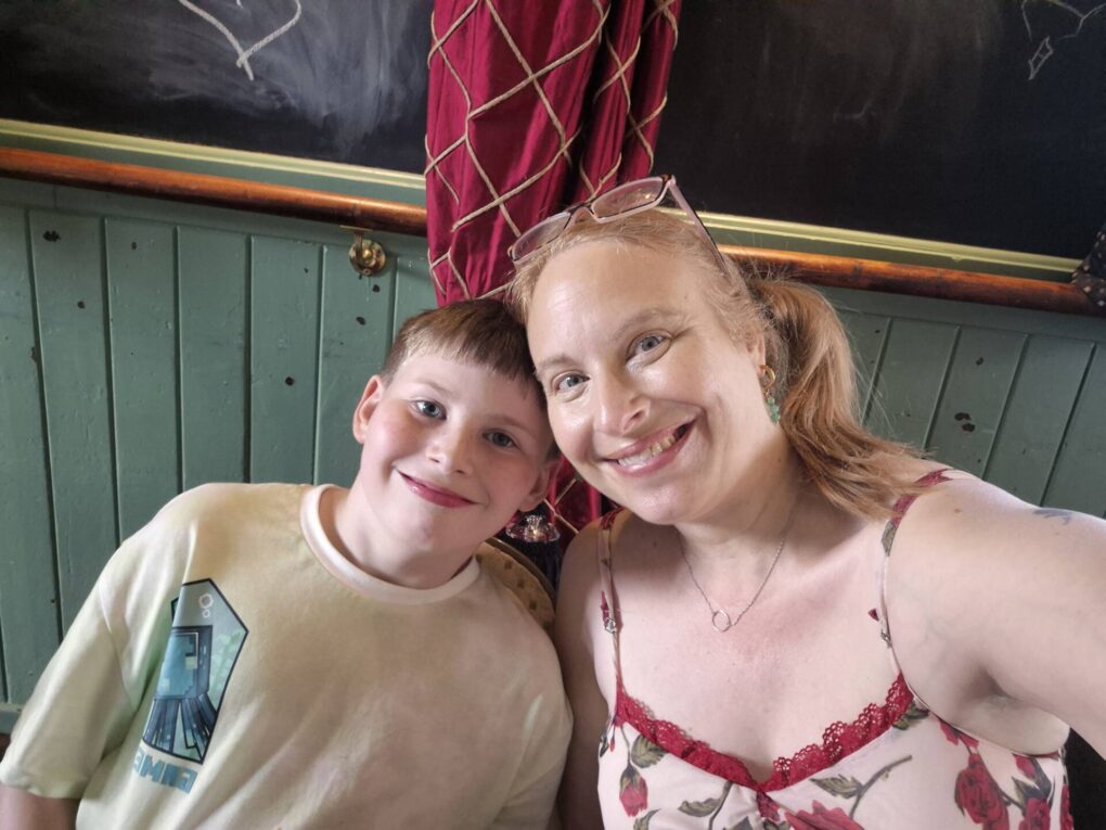 Mother and ten year old smiling into camera