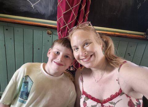 Mother and ten year old smiling into camera
